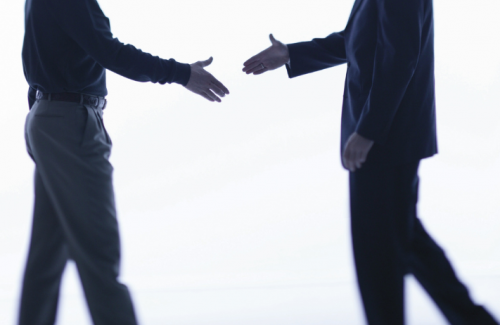 Two people about to shake hands